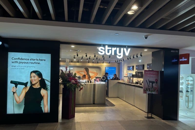 Stryv retail storefront with illuminated logo and product displays