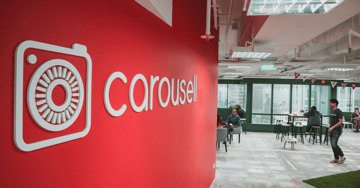 Carousell office with its logo on a red wall beside an open workspace